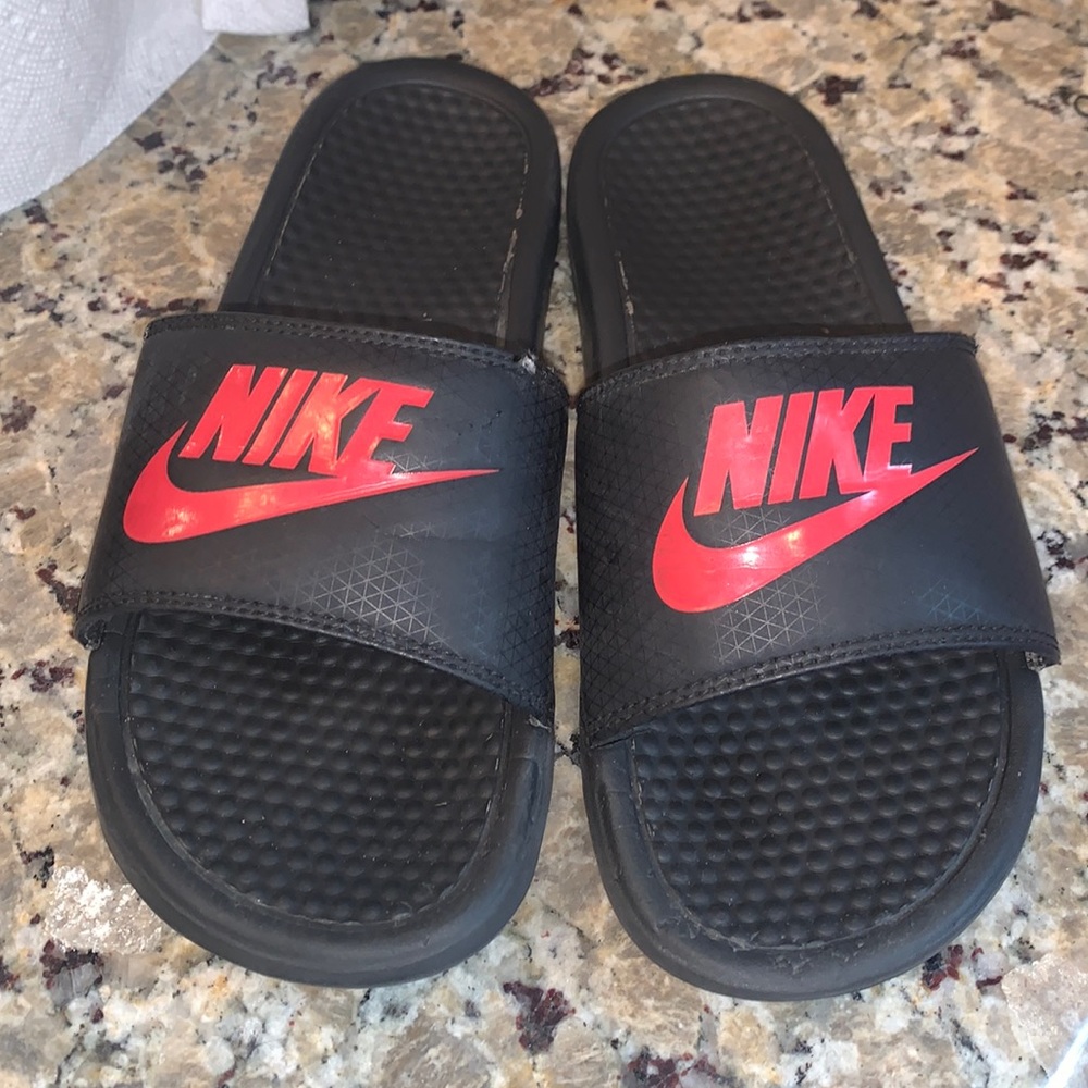 Red and black Nike slides